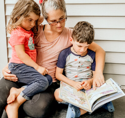 Mother with two kids learning Beast Academy outside